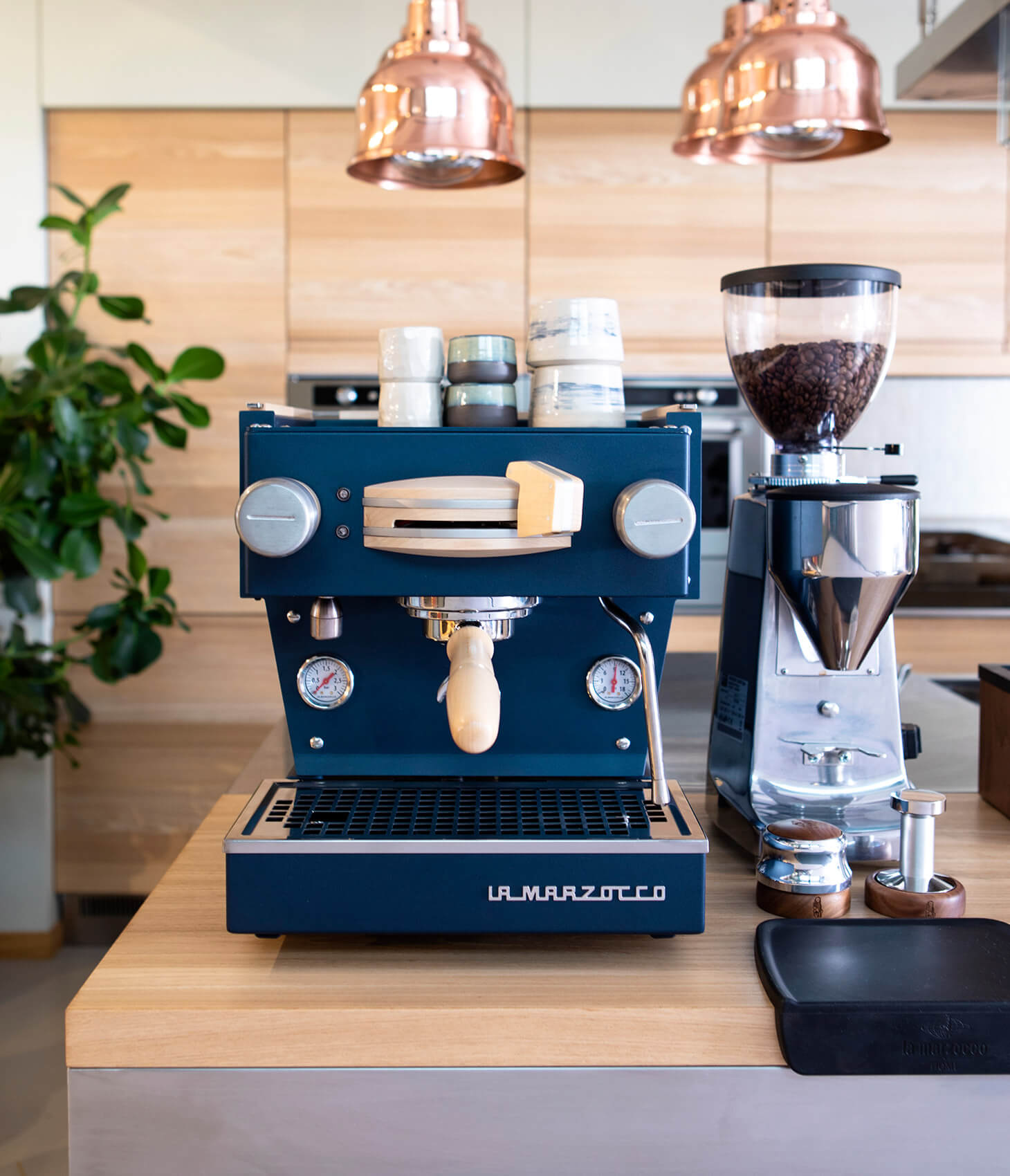 Nordic Linea Mini with navy blue panels and maple details on wooden counter top next to a Mazzer Lux D grinder
