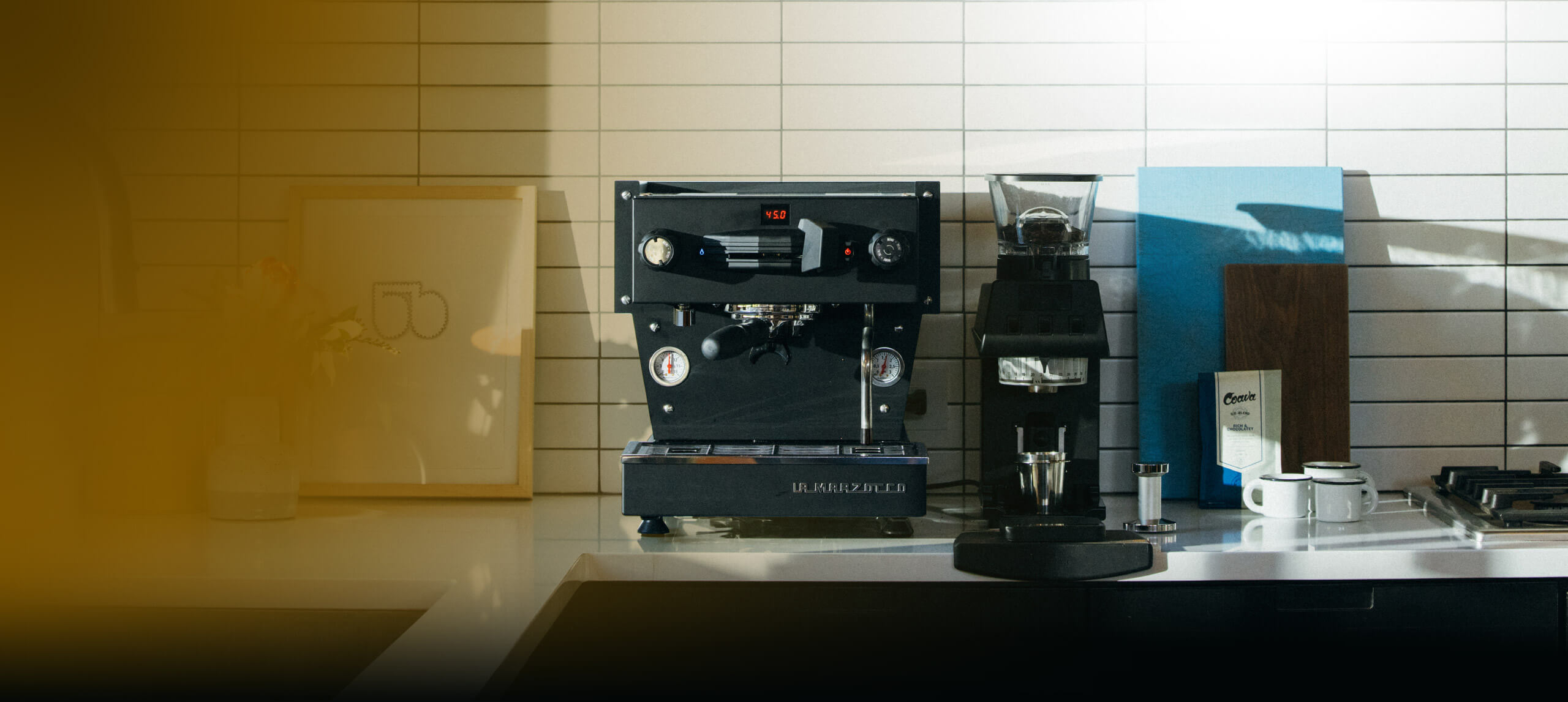 Svart La Marzocco Linea Mini R espressomaskin på köksbänken bredvid Pico. Vidvinkel.